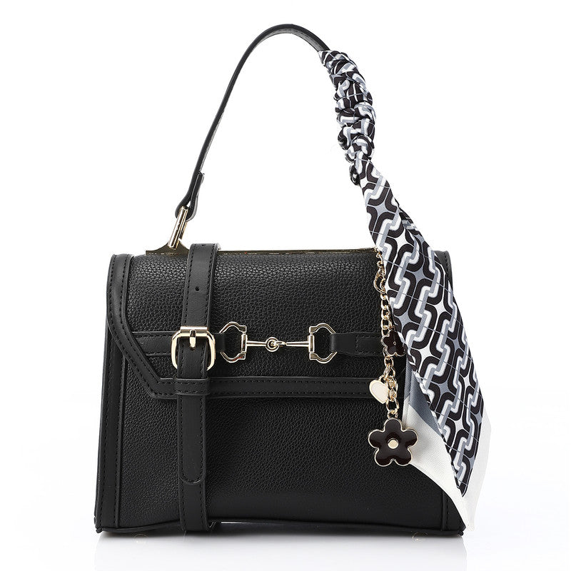 Black handbag with a floral keychain on a white background