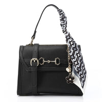 Black handbag with a floral keychain on a white background
