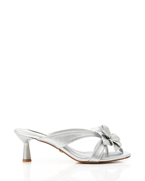 Silver high-heeled sandal with a bow on a white background